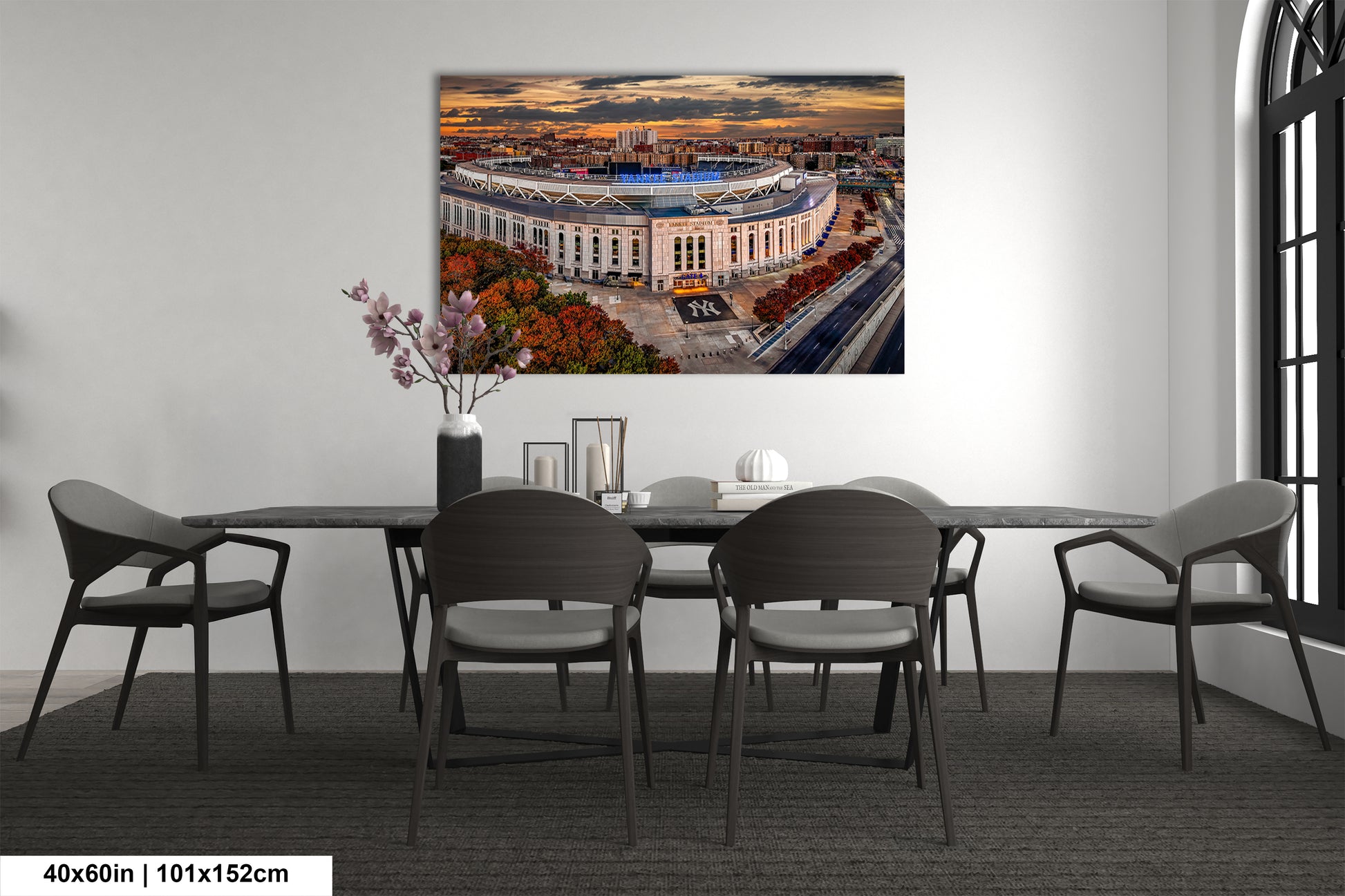 a dining room table with chairs and a painting on the wall