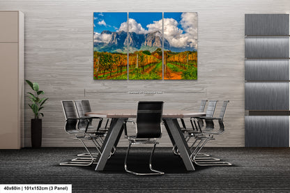 a dining room table with chairs and a painting on the wall
