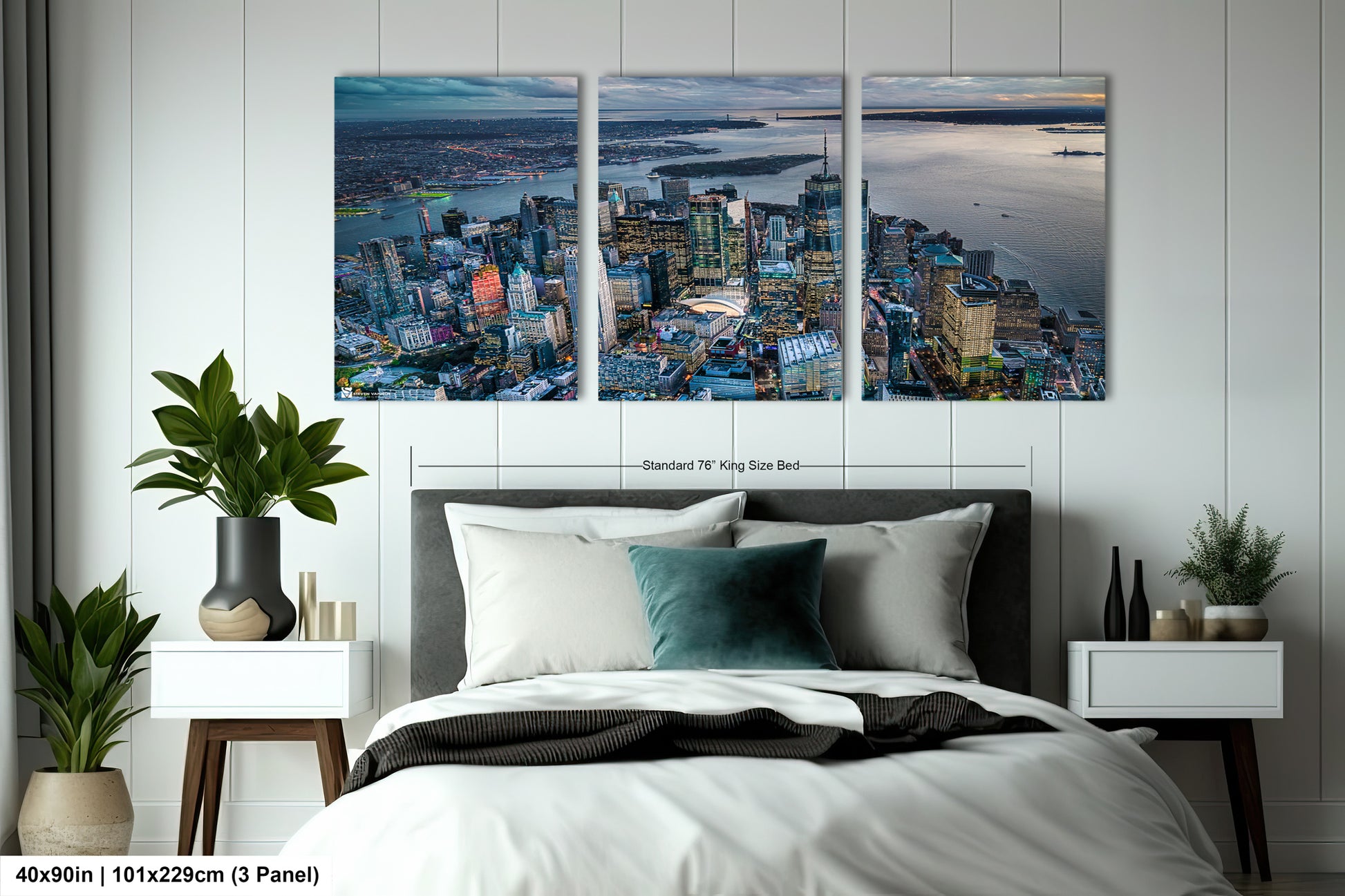 a bedroom with a large bed and two paintings on the wall