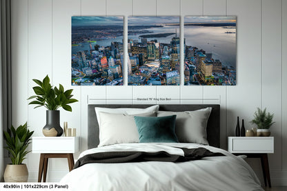 a bedroom with a large bed and two paintings on the wall