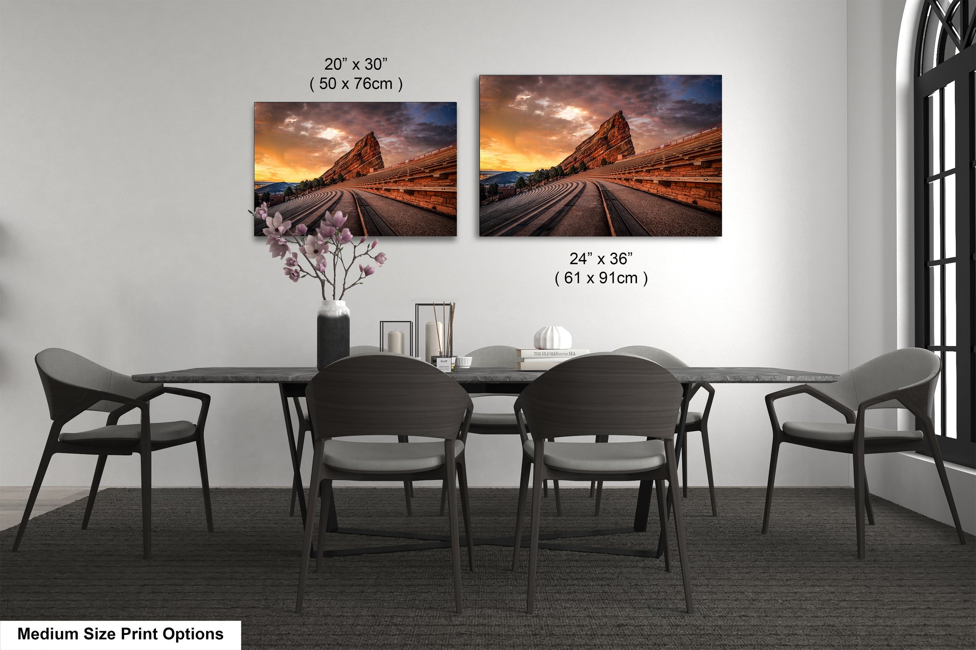 a dining room table with four chairs and two pictures on the wall
