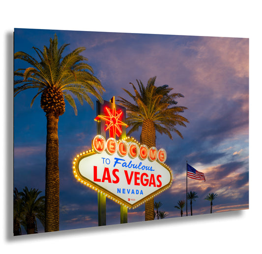 a las vegas sign with palm trees in the background