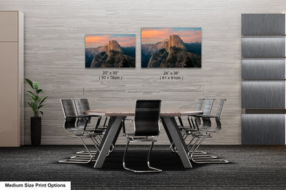 a dining room table with chairs and two pictures on the wall