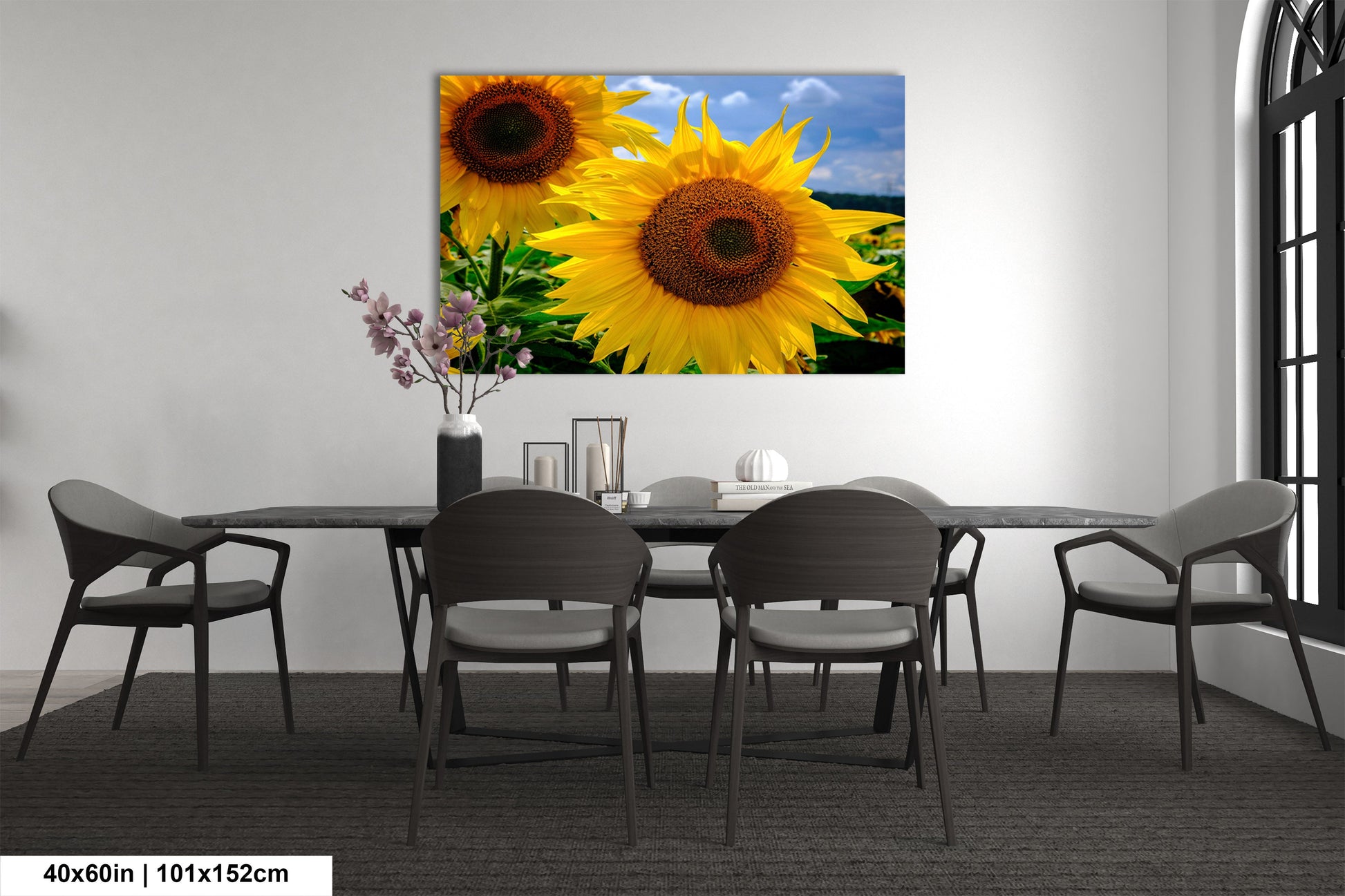 a dining room with a table and chairs and a painting of sunflowers