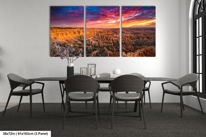 a dining room table with chairs and a painting on the wall