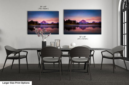 a dining room table with four chairs and two pictures on the wall