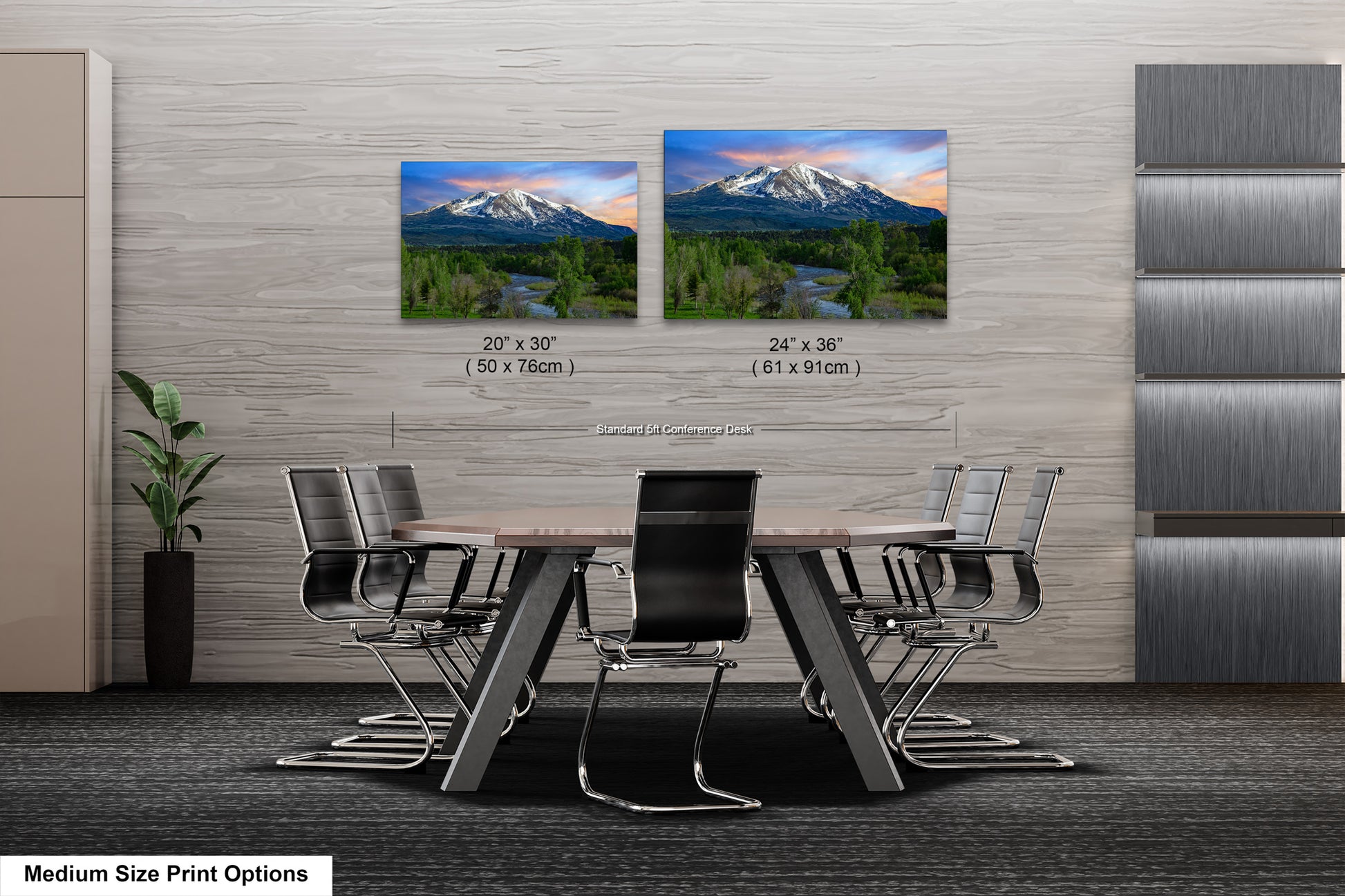 a dining room table with chairs and two pictures of mountains
