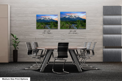 a dining room table with chairs and two pictures of mountains