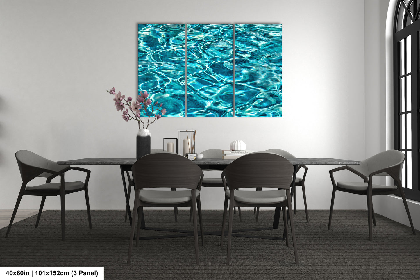 a modern dining room with a large, vibrant blue watercolor painting hanging on the wall above a black table surrounded by matching chairs.