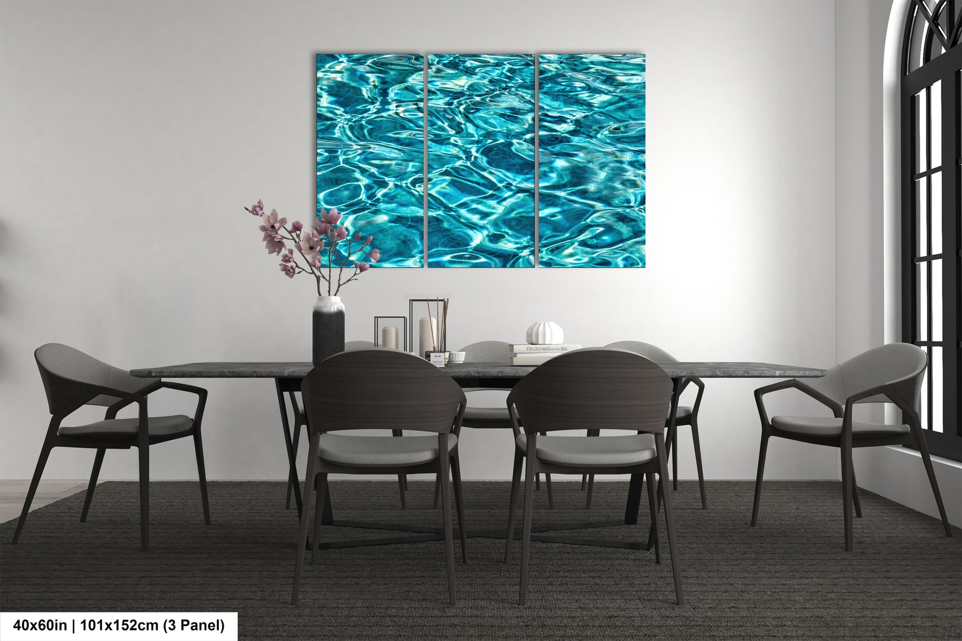a modern dining room with a large, vibrant blue watercolor painting hanging on the wall above a black table surrounded by matching chairs.