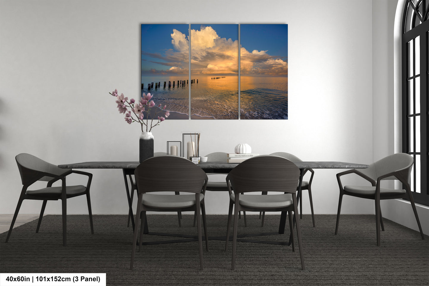 a dining room table with four chairs and a painting on the wall