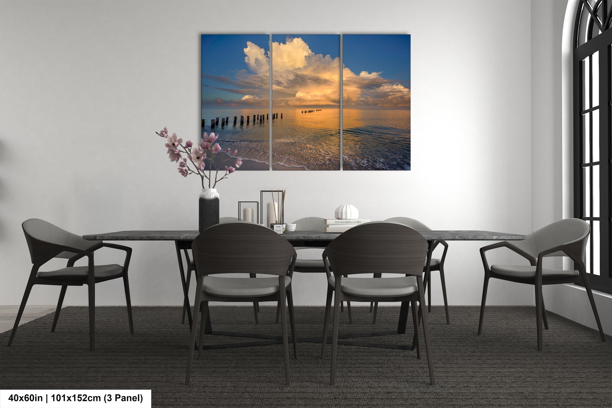 a dining room table with four chairs and a painting on the wall