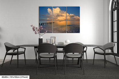 a dining room table with four chairs and a painting on the wall