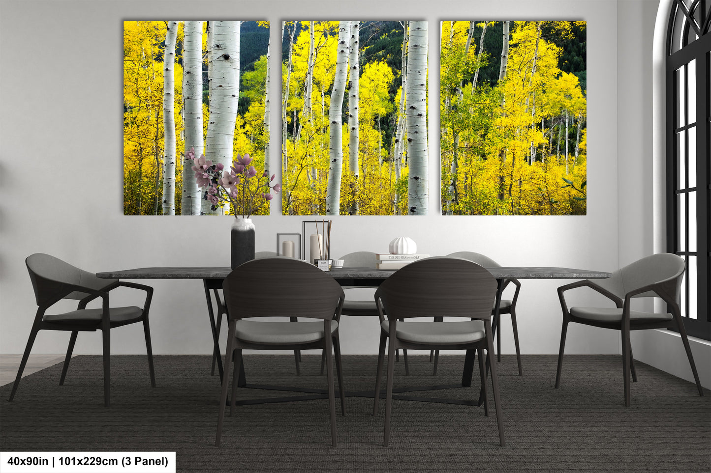 a dining room table with four chairs and a painting on the wall