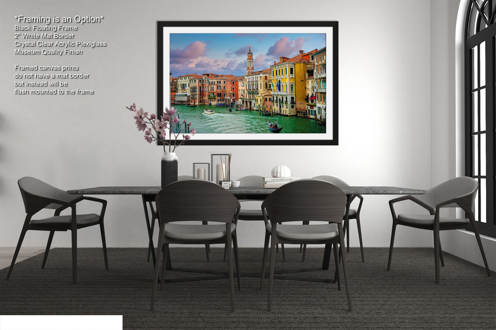 a dining room with a picture hanging on the wall
