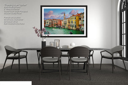 a dining room with a picture hanging on the wall