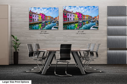 a dining room table with chairs and two pictures of buildings