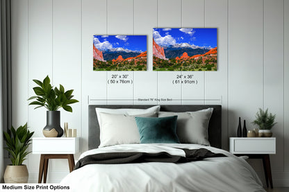 a bedroom with a bed and two pictures on the wall