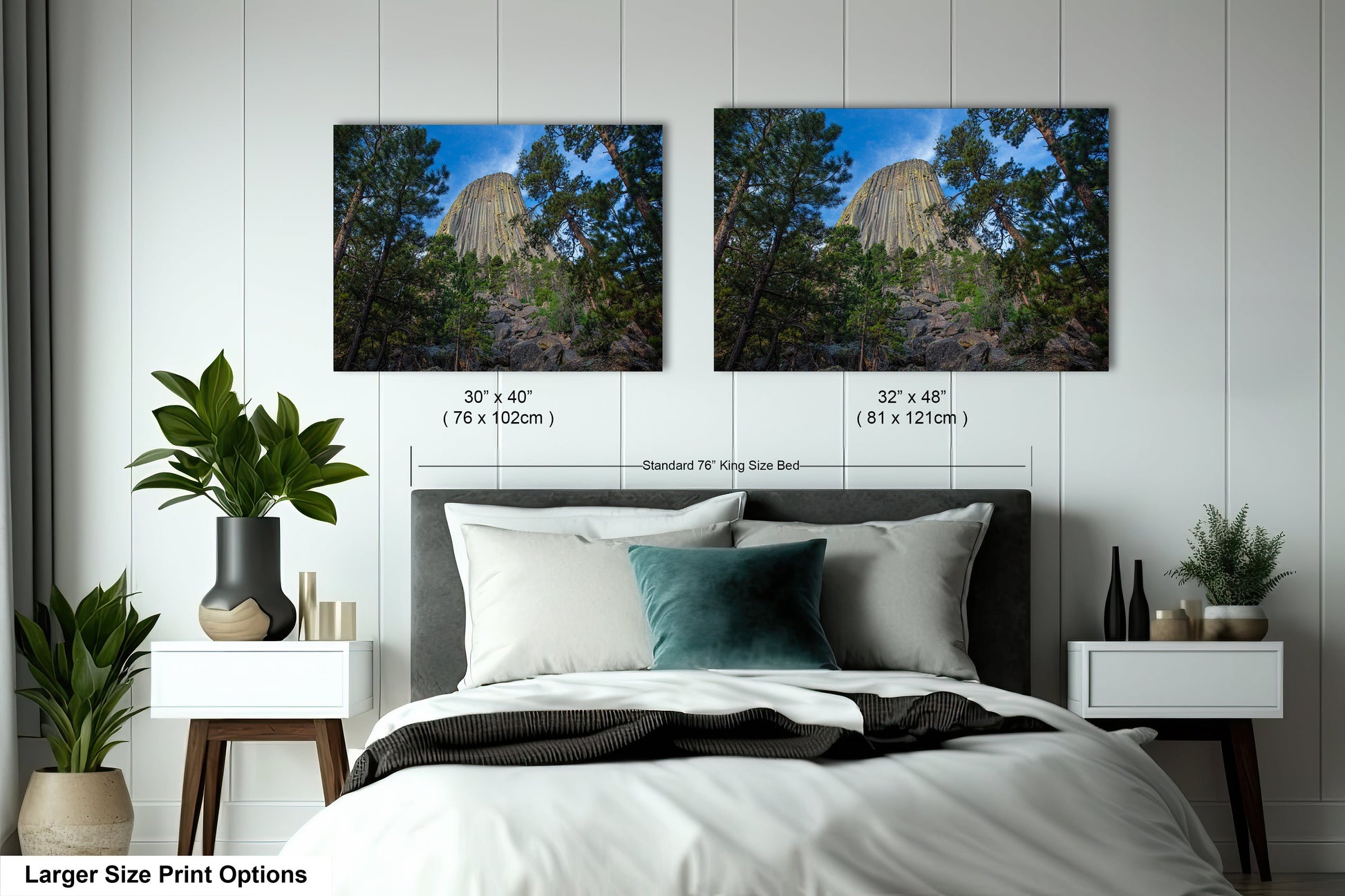 a bed with two pictures on the wall above it