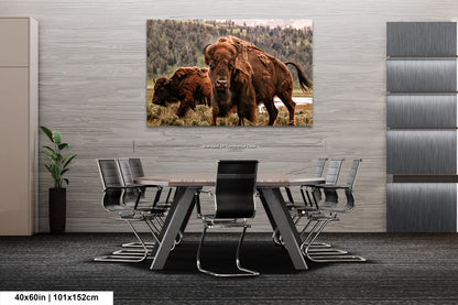 a couple of bison standing next to each other on a table