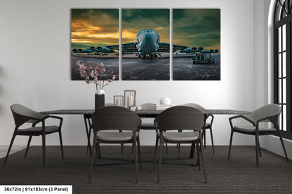 a dining room table with four chairs and a large painting of an airplane