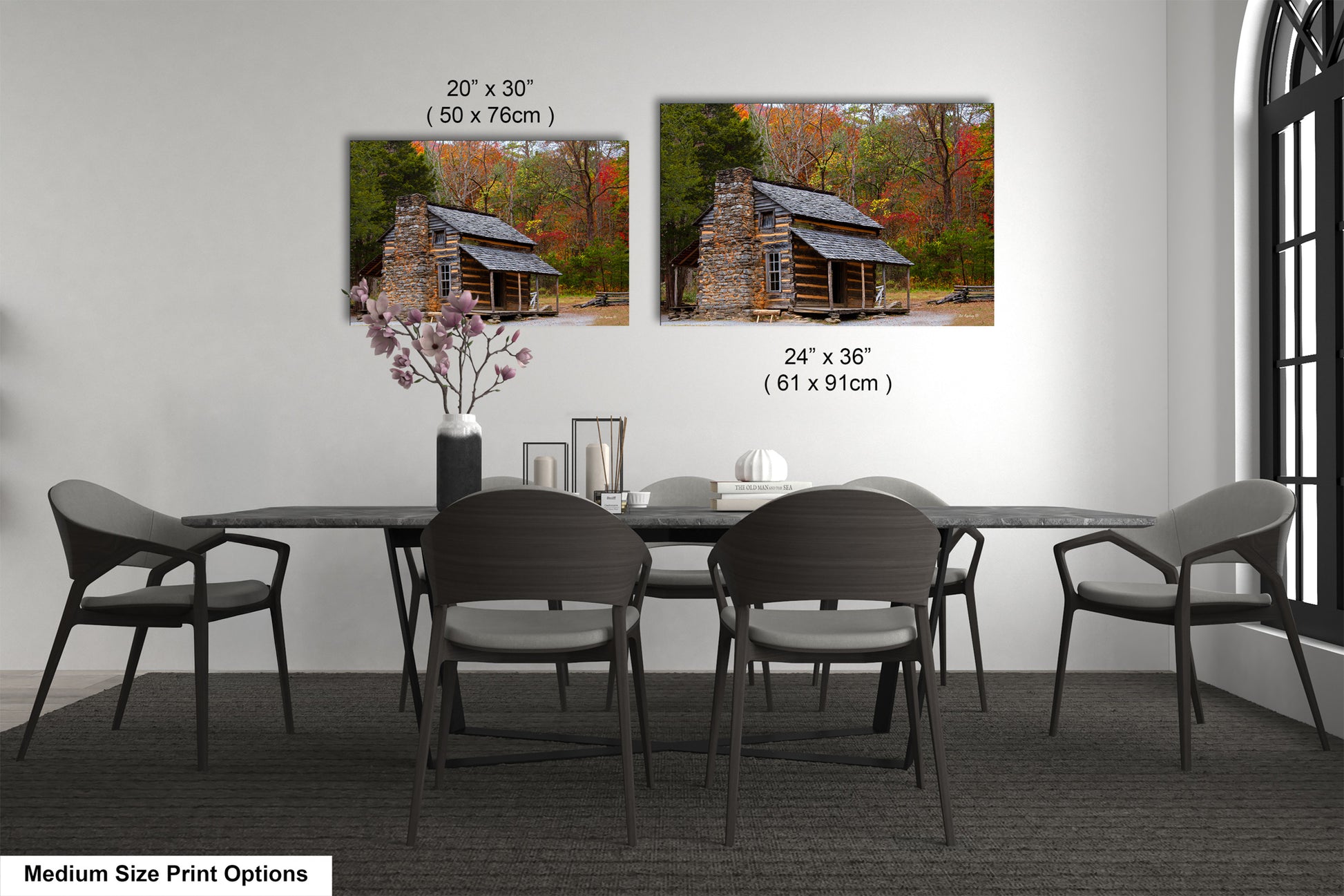 a dining room table with four chairs and a picture of a log cabin on the