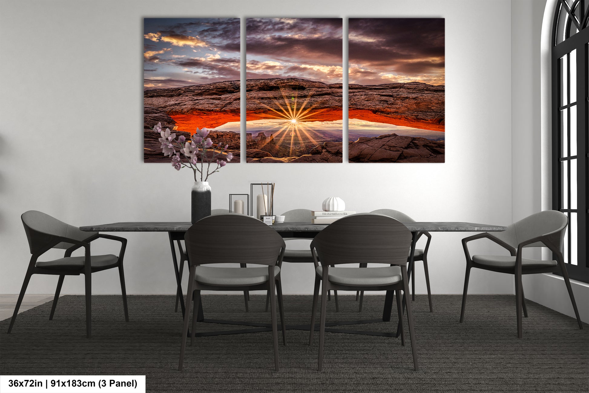 a dining room table with chairs and a painting on the wall