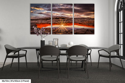a dining room table with chairs and a painting on the wall