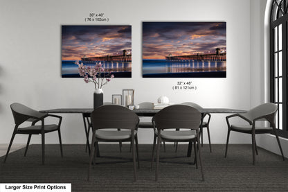a dining room table with chairs and a vase of flowers