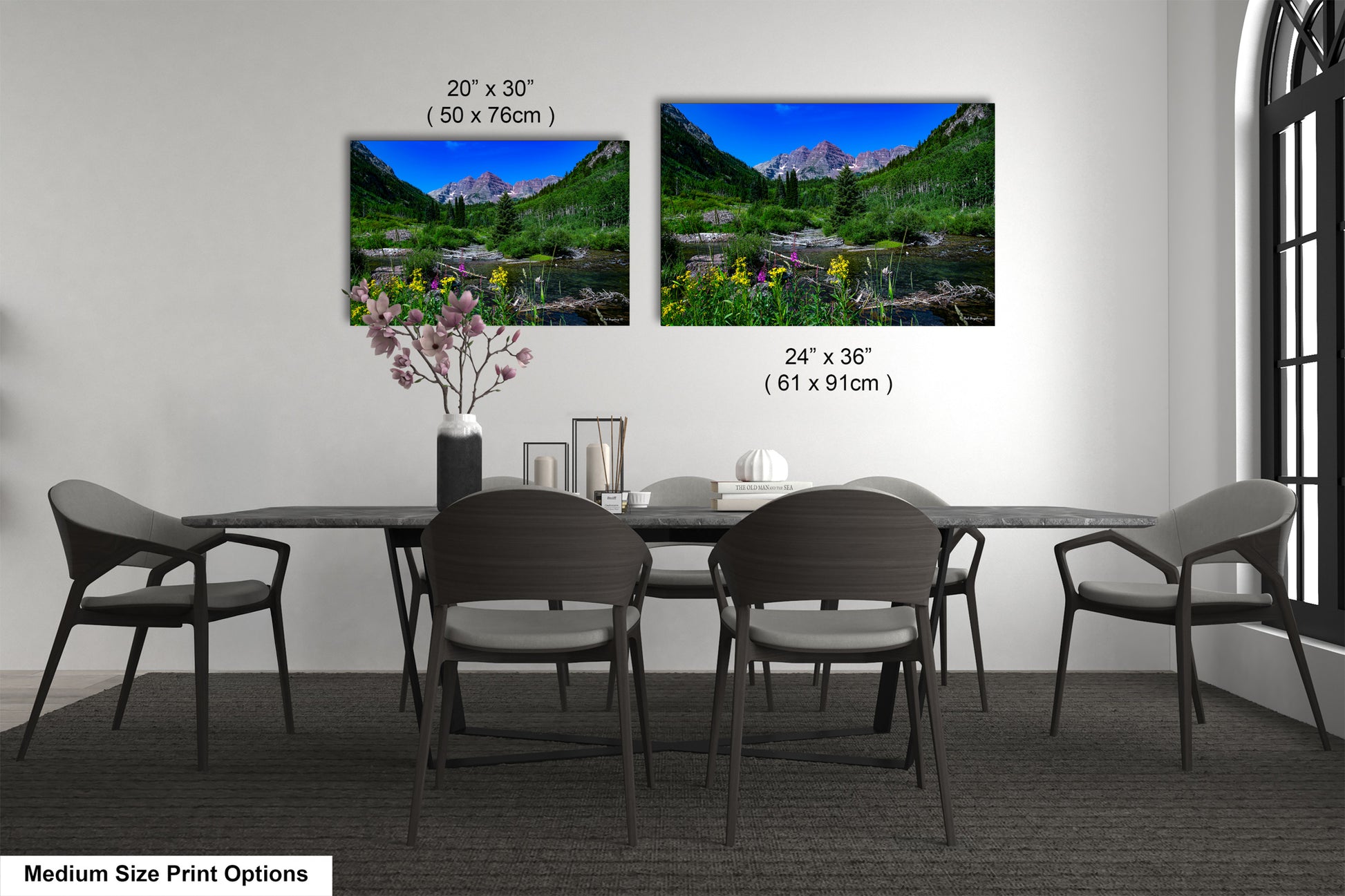 a dining table with four chairs and a vase of flowers