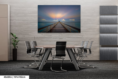 a dining room table with chairs and a painting on the wall