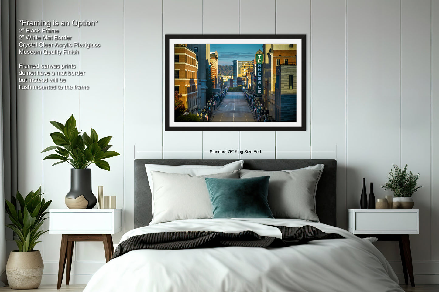 a bedroom with a large bed and a picture on the wall