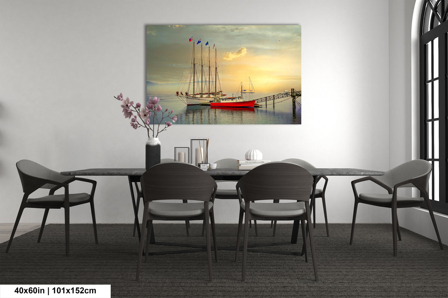a dining room table with chairs and a painting on the wall