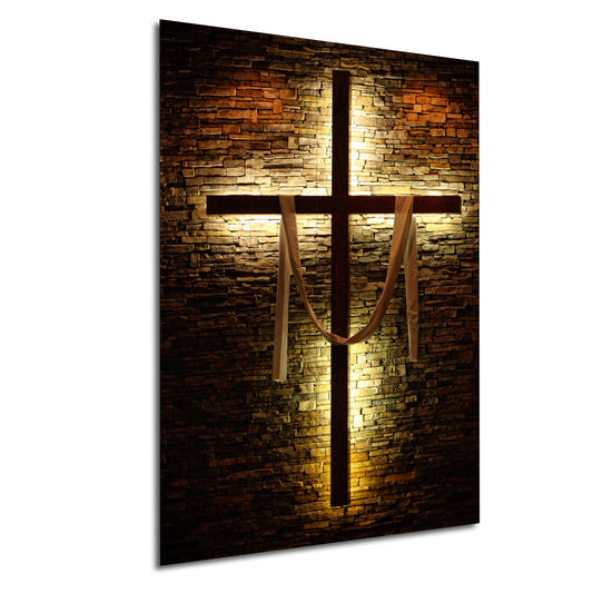 a cross on a brick wall with a light shining on it