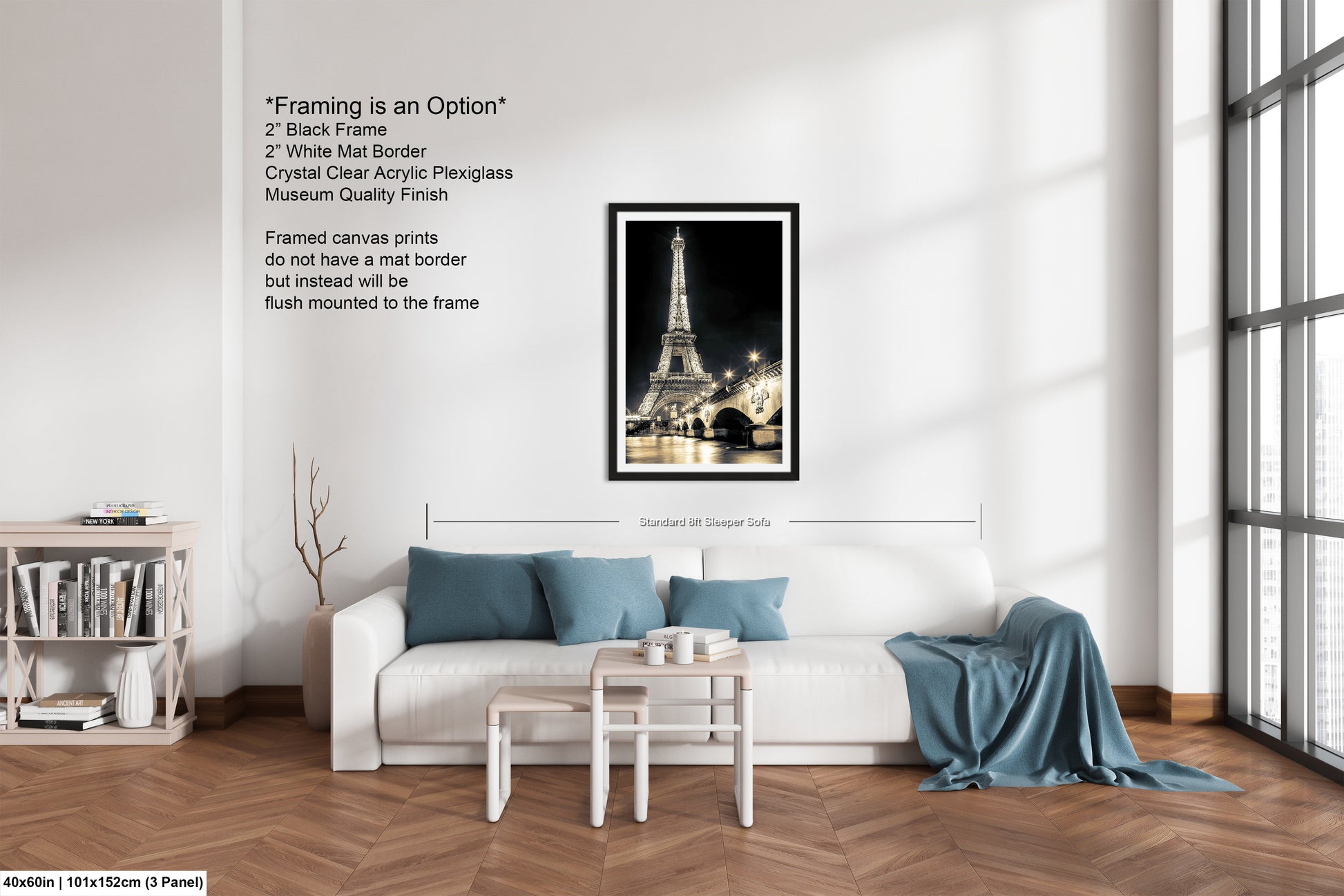 a living room with a white couch and a picture of the eiffel tower