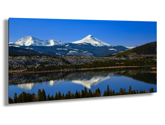 a mountain range with a lake in the foreground