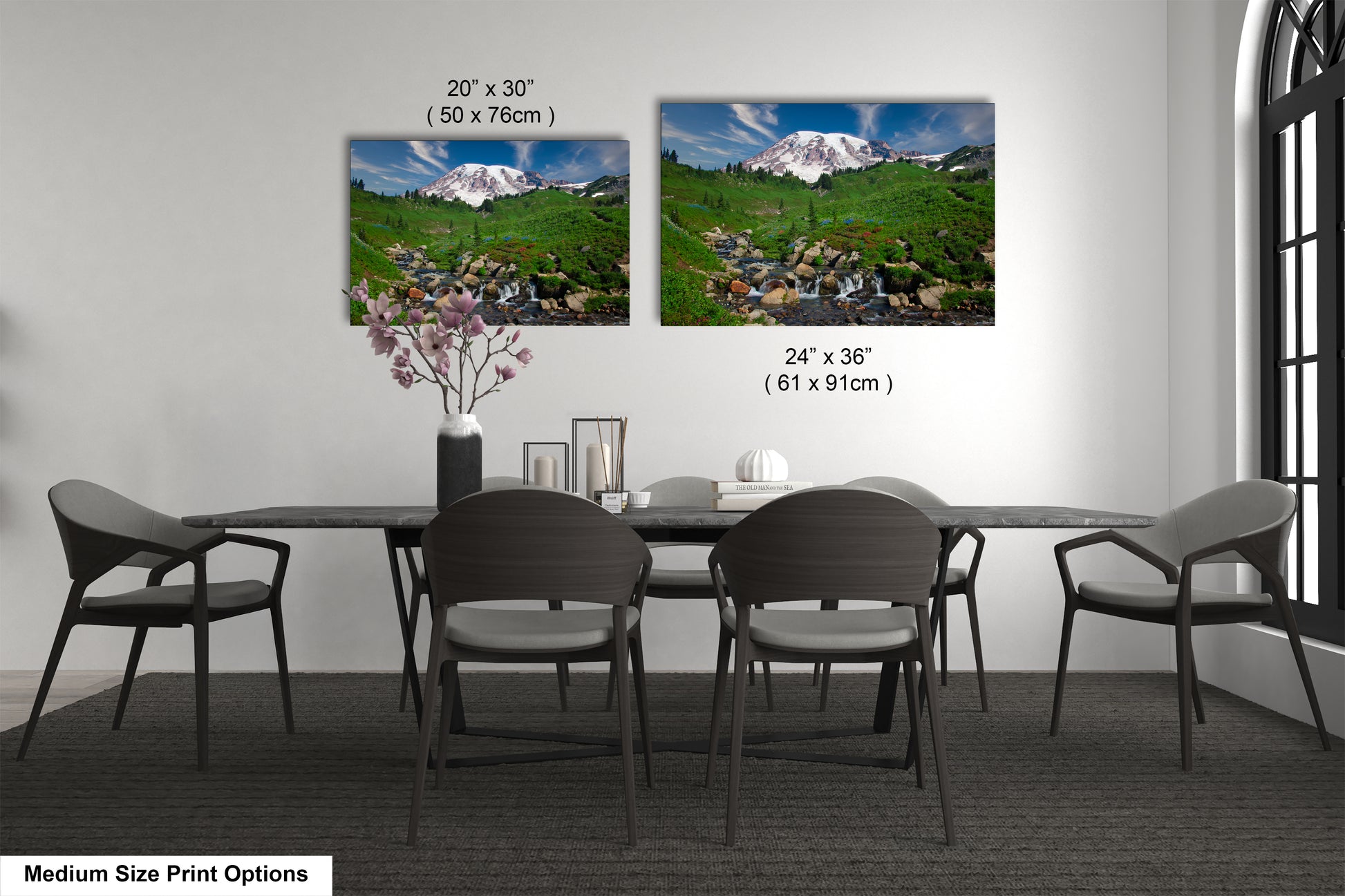 a dining table with four chairs and a vase with flowers