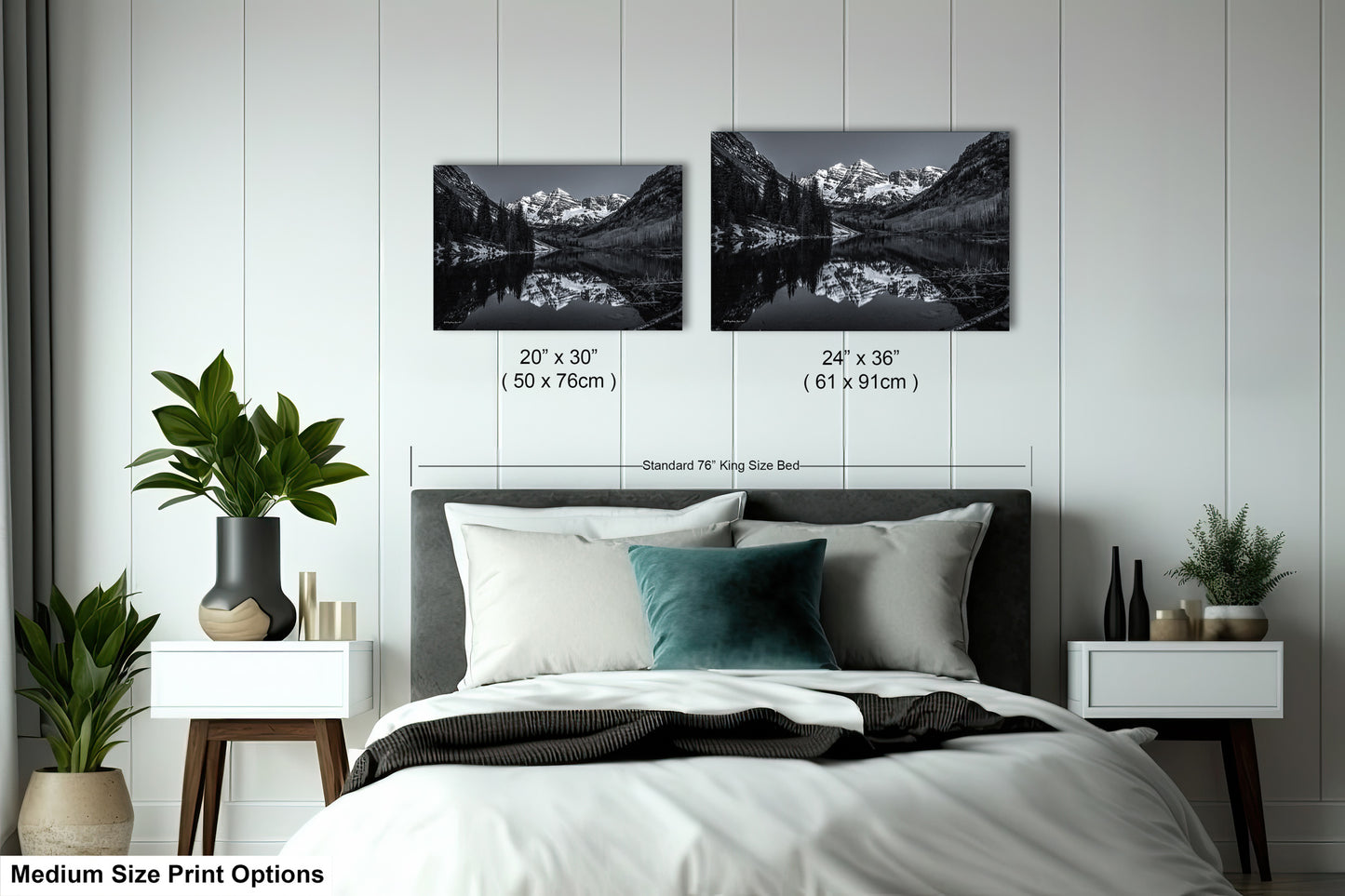 a bed with a white comforter and two black and white pictures on the wall