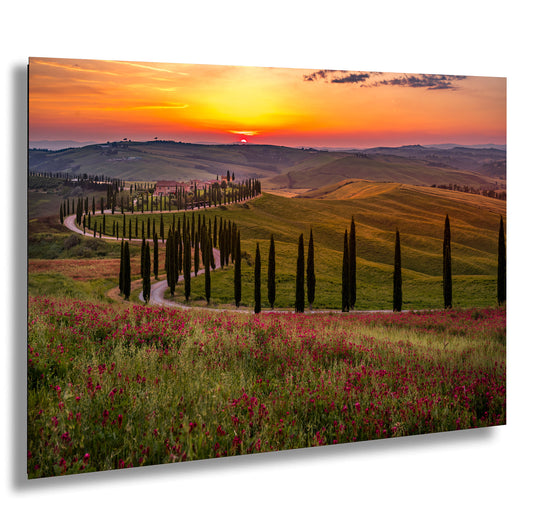 the sun is setting over the rolling hills