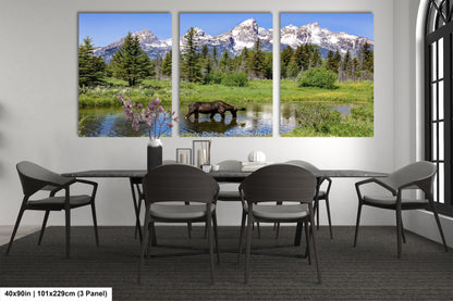 a dining room table with four chairs and a painting of a moose