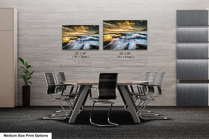 a dining room table with four chairs and two pictures on the wall