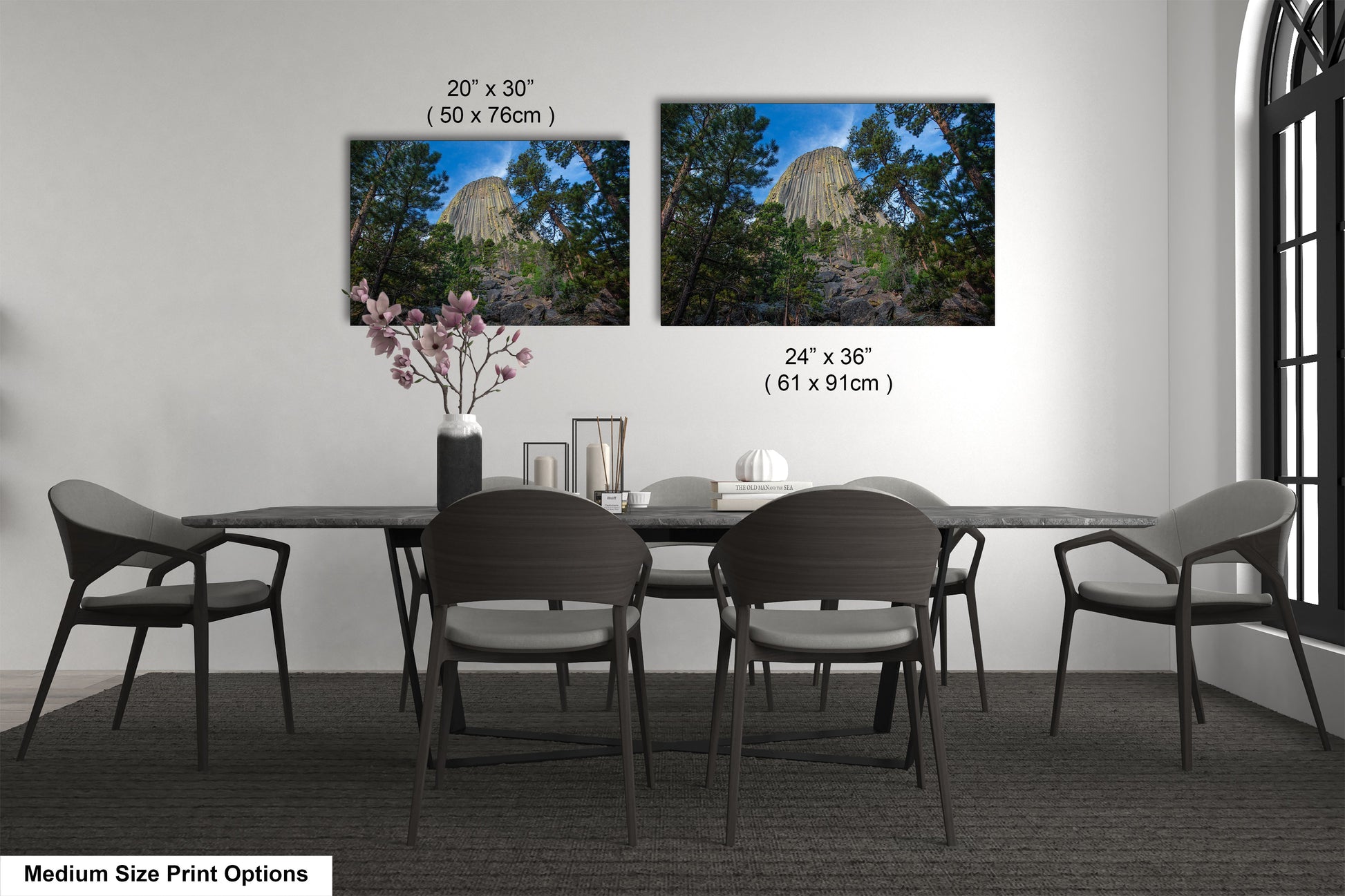 a dining table with four chairs and a vase of flowers
