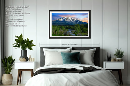 a bedroom with a bed and a picture hanging on the wall