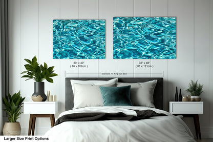 a bedroom with a bed, nightstands, and a large painting of water on the wall above the bed.