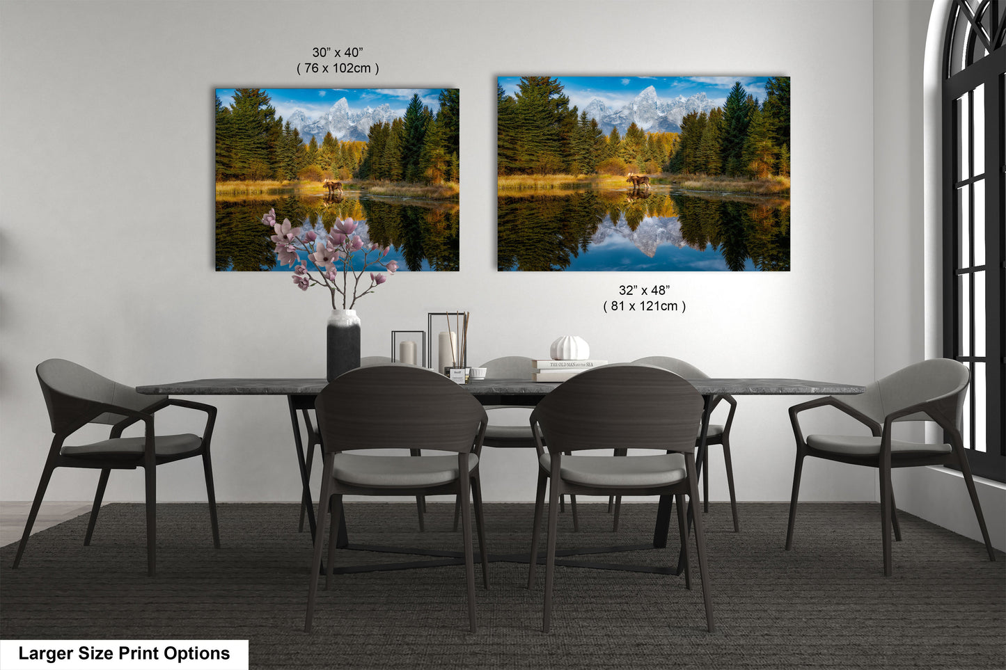 a dining room table with four chairs and two pictures on the wall