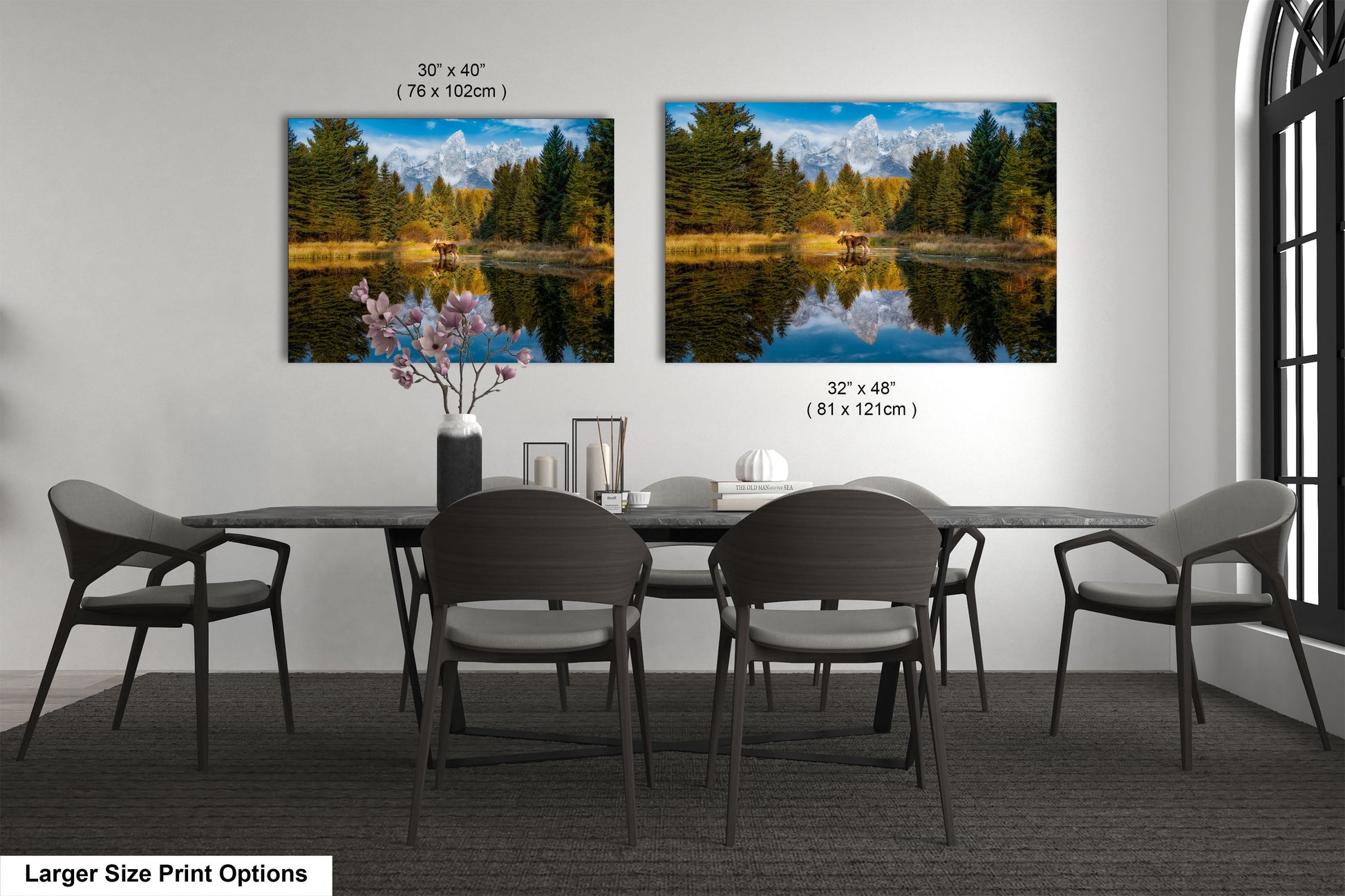 a dining room table with four chairs and two pictures on the wall