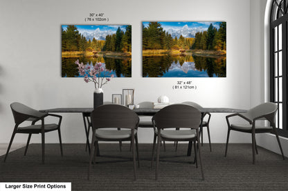 a dining room table with four chairs and two pictures on the wall
