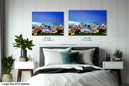 a bedroom with a bed and two pictures on the wall
