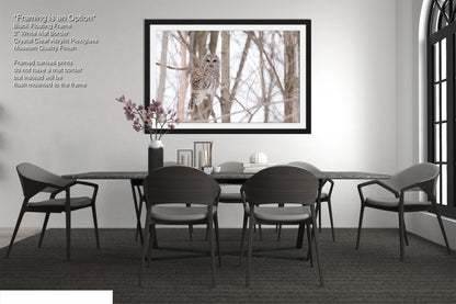 a dining room table with chairs and a vase of flowers