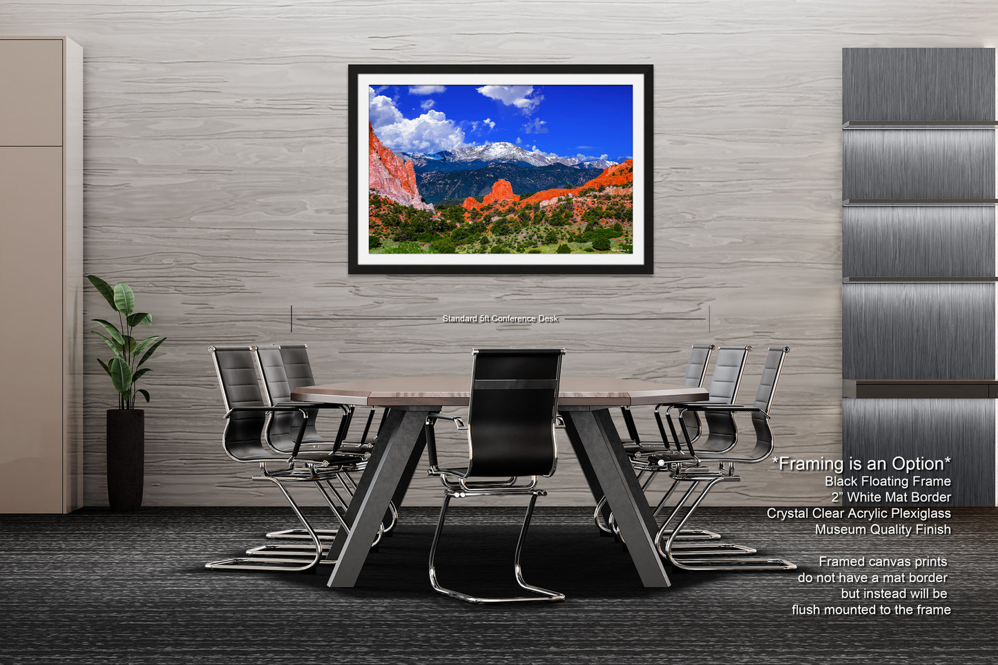 a dining room table with chairs and a picture hanging on the wall